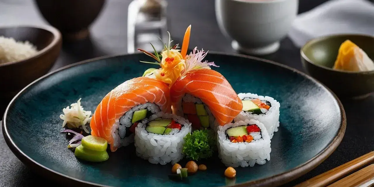 Wykwintne rolki sushi z łososiem, awokado i warzywami, podane z dodatkami do sushi: wasabi, imbirem i sosem.