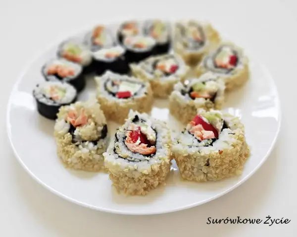 Talerz sushi z hosomaki takuan, łososiem i warzywami. Roladki ryżowe w sezamie i nori.