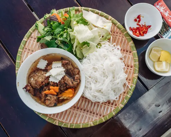 Pyszne bun chay: grillowane mięso, ryżowy makaron, świeże zioła, warzywa, chili i cytryna.